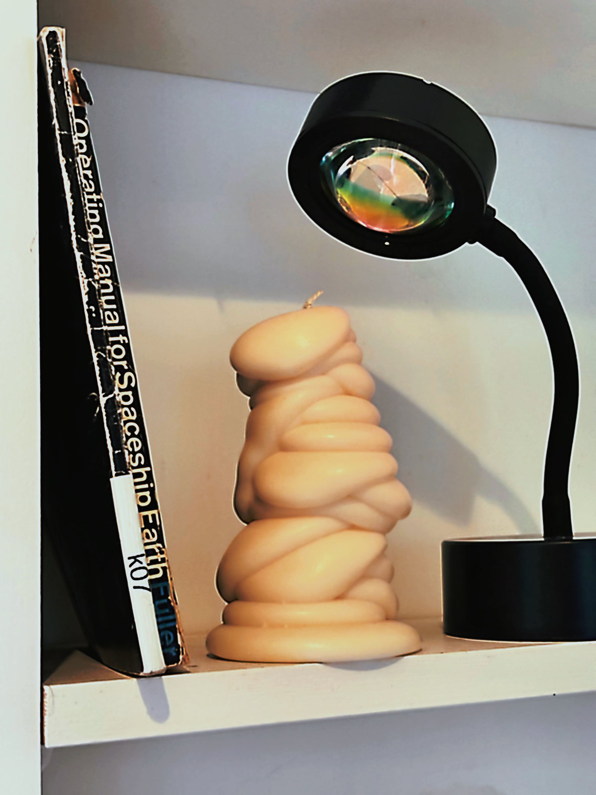 post objects shaped candle flow series drip candle on white shelf with designer art book